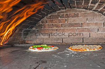 Pizzas cooking in an oven