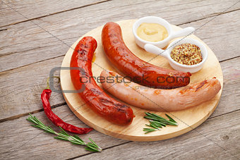 Various grilled sausages with condiments