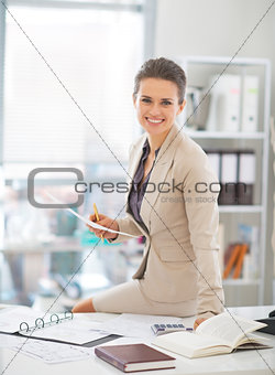 Portrait of happy business woman working in office