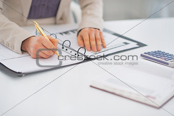 Closeup on business woman working with document