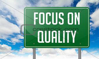 Focus on Quality in Green Highway Signpost.