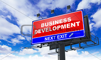Business Development Inscription on Red Billboard.