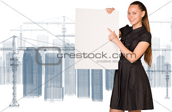 Businesswoman holding empty paper. Construction site with tower cranes