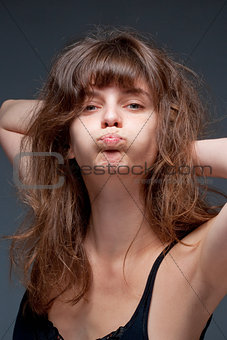  Young Woman with Brown Hair Making a Face