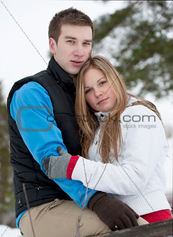 Gentle embrace of a young couple in love outside in winter