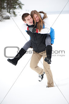 Young cheerful couple on a walk in winter