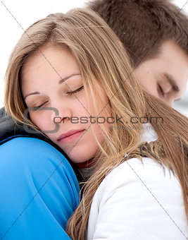 Gentle embrace of a young couple in love outside