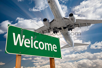 Welcome Green Road Sign and Airplane Above