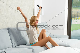 girl exulting on sofa 
