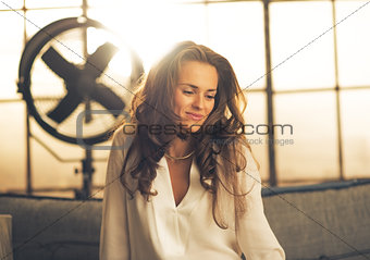 Portrait of elegant young woman in loft apartment