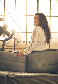 Portrait of smiling young woman in loft apartment