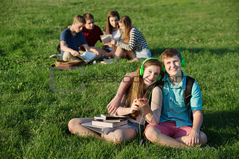 Teen Couple Sitting Outdoors