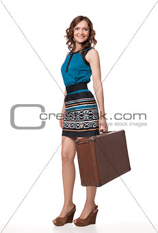 Portrait of happy young woman with suitcase