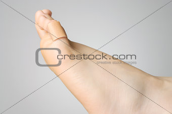 Closeup of a plaster on female toe
