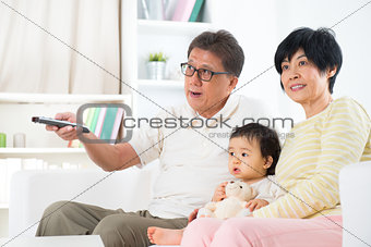 Asian family watching tv