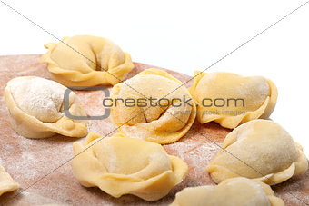 Homemade ravioli on kitchen wooden board