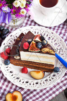 Piece of chocolate cake with cream and fresh fruit