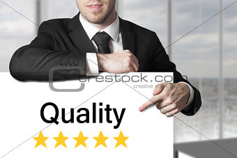 businessman pointing on sign quality