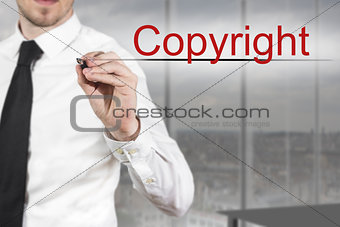 businessman writing copyright in the air
