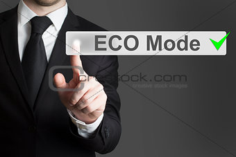 businessman pushing touch screen button eco mode
