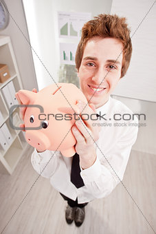 wide angle of a clerk with a piggy bank