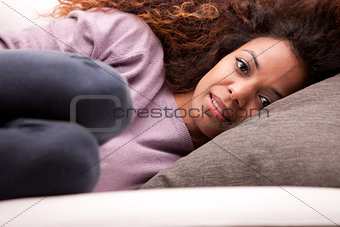 beautiful african-american woman lying on a sofa