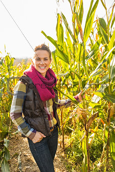 Portrait of smiling young woman in cornfield