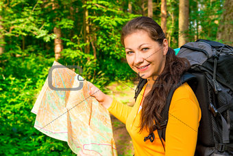 beautiful girl seeks the path to map forest