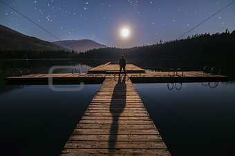 Man Looking At Moon on Dock in Whistler