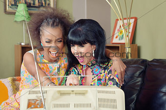 Pair of Ladies Laughing at TV