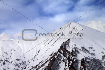 Off-piste slope in morning and sky with clouds
