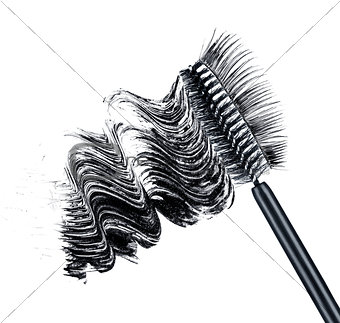 smear of black brush mascara and false eyelashes isolated on whi