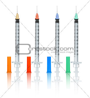 collection needles and syringes with caps on an isolated white b