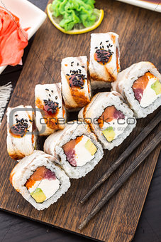 Sushi roll with salmon, tuna and eel