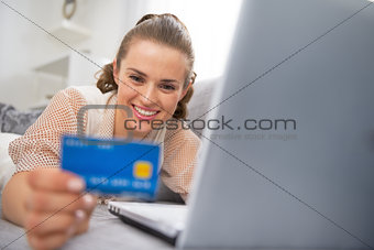Happy young woman making online shopping
