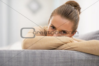 Closeup on stressed young housewife in living room