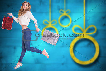 Composite image of pretty blonde with shopping bags