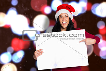 Composite image of woman pointing at white sign