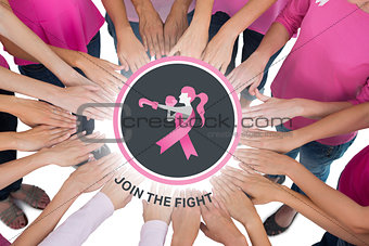 Composite image of hands joined in circle wearing pink for breast cancer