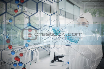 Composite image of chemist in protective suit working with futuristic interface with formula diagram
