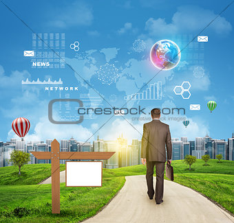 Businessman walks on road. Rear view. Buildings, grass field and sky with virtual elements