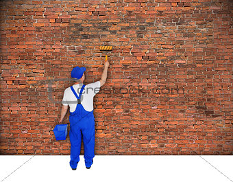 house painter paints brick wall 