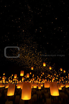 beautiful Lanterns flying on the water and in the night sky