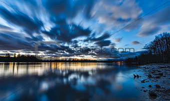 Blue Blurred Moving Clouds Over River