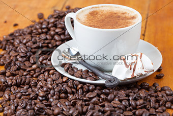 Freshly brewed cup of coffee served with meringue