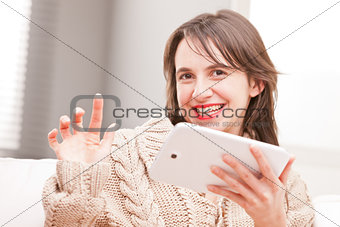 woman succesfully using her tablet and smiling