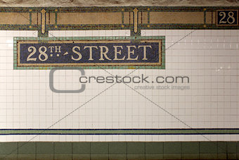 New York City Station subway 28th Street  sign on tile wall.
