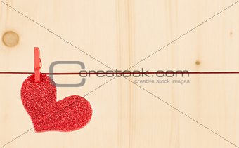 one decorative red heart hanging on wood background, concept of valentine day