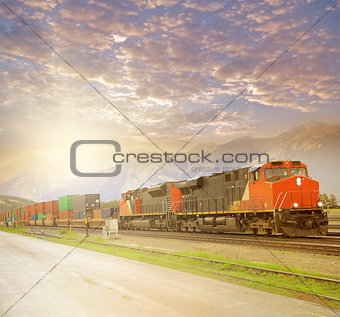 Freight train in Canadian rockies at sunset.