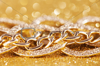 close up of gold chainlet. luxe golden glitter background